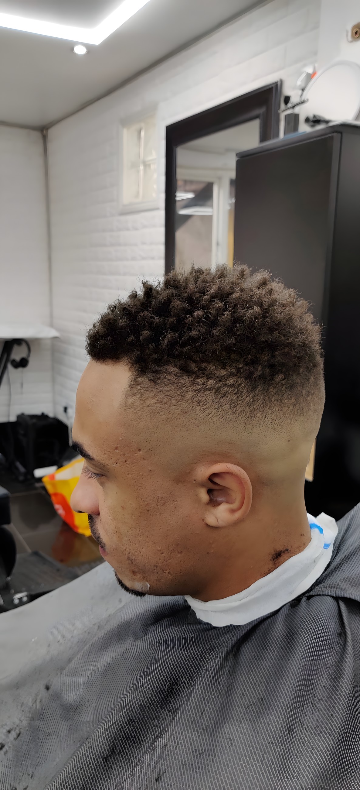 Textured high-top cut with a sharp fade