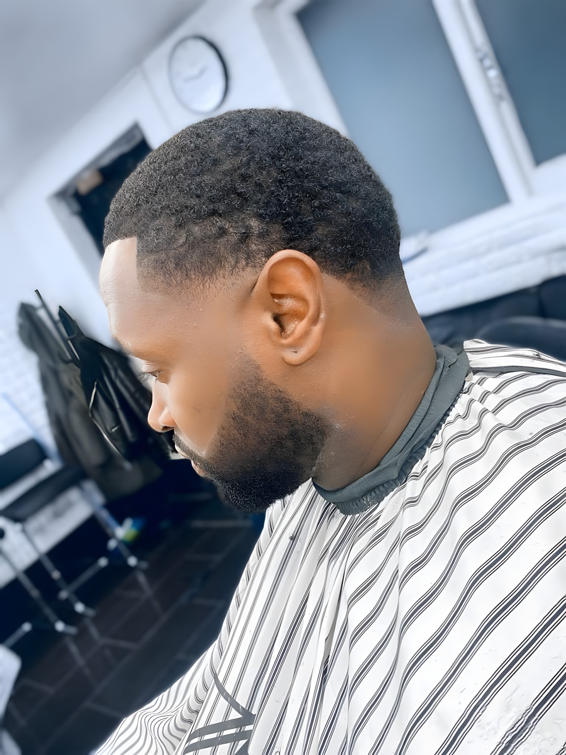 Side profile of a clean fade and beard blend