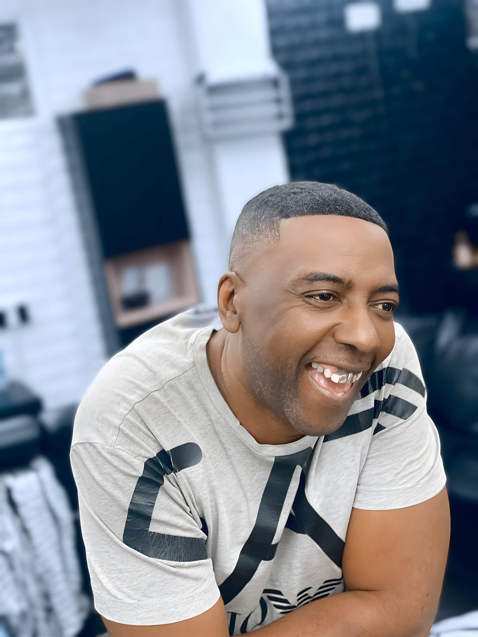 A barber at Fade Fabric smiling in the shop
